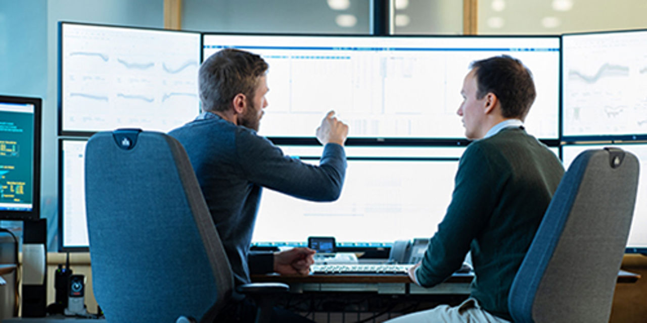 Men working on monitor