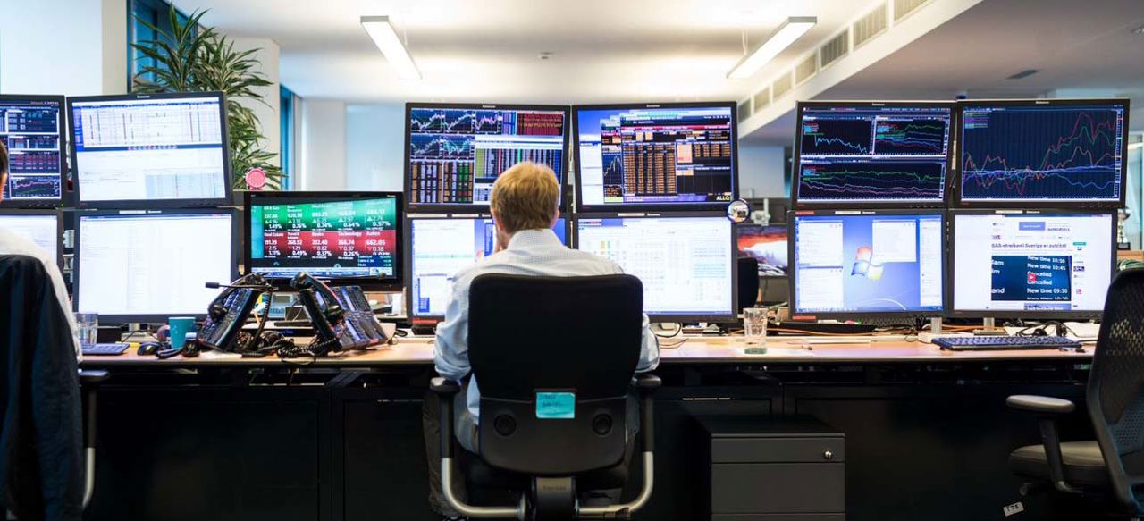 Man in front of monitors