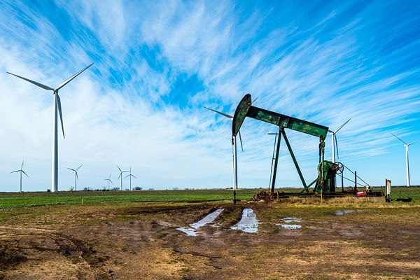 Wind turbines and an old oil rig